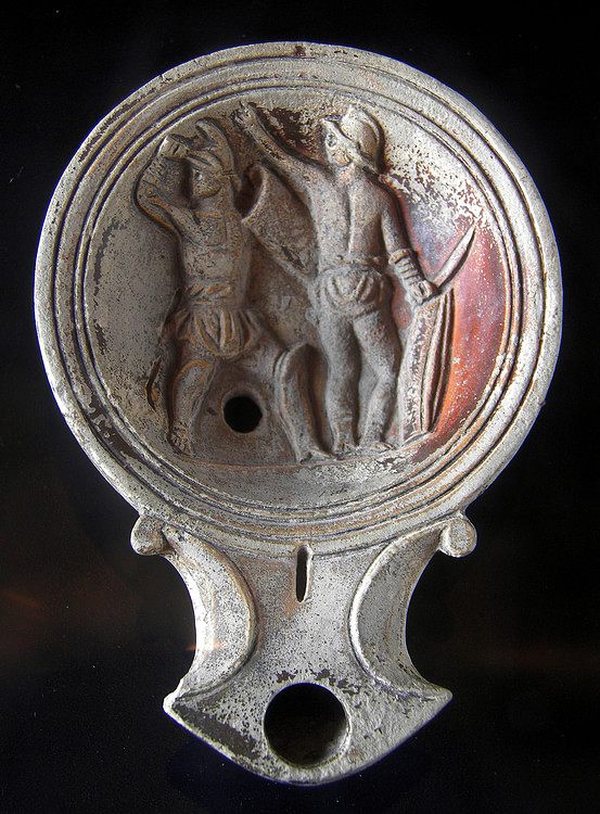 Terracotta oil lamp with gladiators